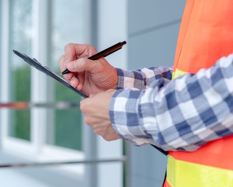 A person with a clipboard checking a list