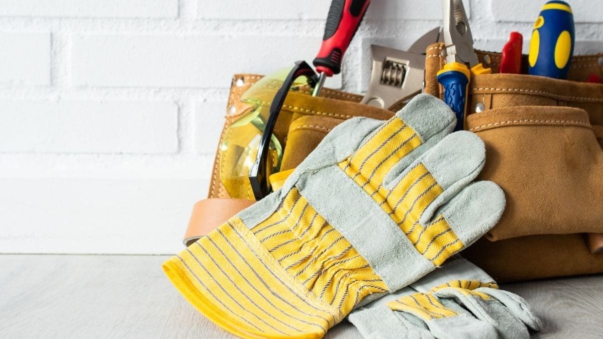 Handyman tools in a belt with gloves