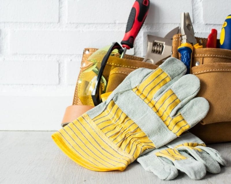 Handyman tools in a belt with gloves