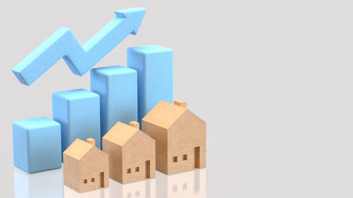 An illustration of houses with a graph behind them