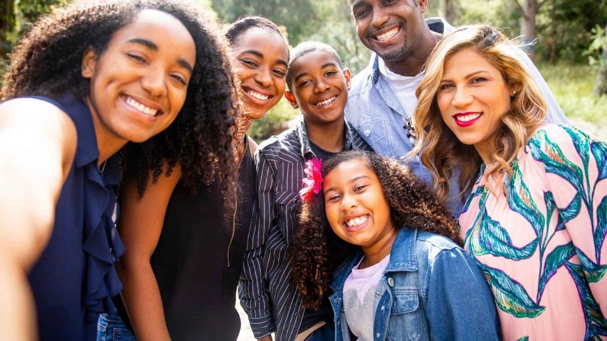 A smiling family six posing the camera