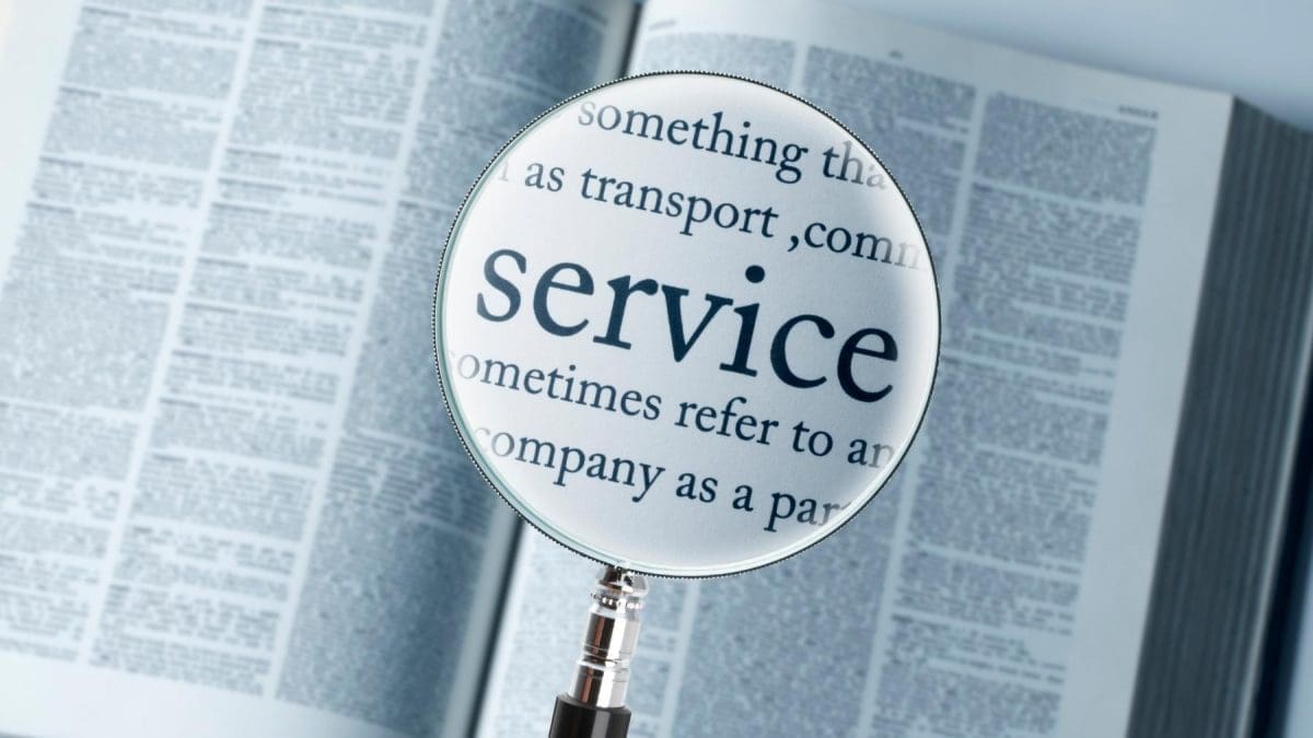 a book with a magnifying glass in the middle of the page, the magnifying glass is focused on the word service